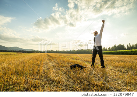 Businessman in the Field Raising Arm for Success Businessman in the Field Raising Arm for Success 122079947