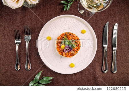 Portion of salmon tartare with chopped avocado 122080215