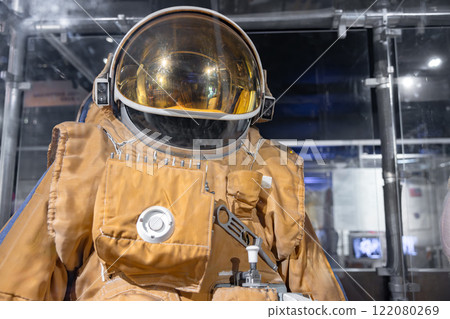 Working spacesuit against technology background 122080269