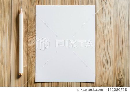 Top view of a regular pencil next to a blank sheet of white textured watercolor paper on a light brown wooden table. Suitable for advertising related to creativity, art, education and office supplies 122080738