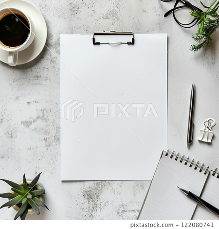Top view of an open notebook and tablet with blank pages next to a cup of coffee on the table. Ready to add text or layout. Suitable for advertising related to business, education and stationery 122080741