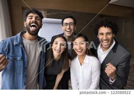 Group of five happy multiracial staff members celebrate business achievements Group of five happy multiracial staff members celebrate business achievements 122080822