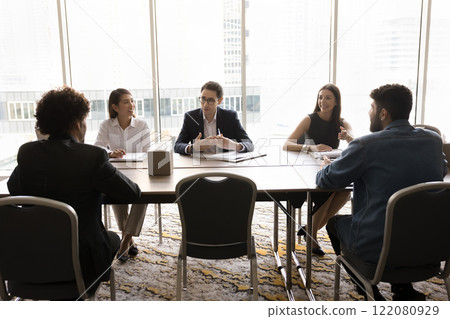 Young Arabian businessman dressed in suit speaking with colleagues Young Arabian businessman dressed in suit speaking with colleagues 122080929
