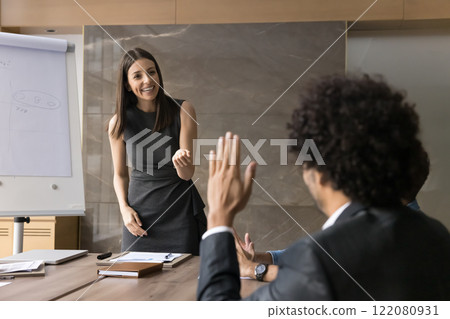 Businessman in suit raising hand at corporate diverse group meeting 122080931
