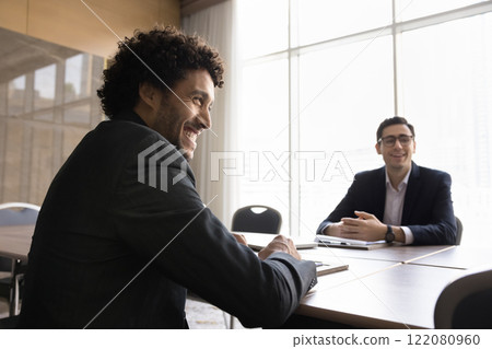 Group meeting of young cheerful Arabian male entrepreneurs in office Group meeting of young cheerful Arabian male entrepreneurs in office 122080960