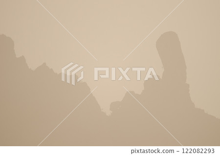 Rocky cliff under a dense haze. Rocky cliff under a dense haze. 122082293