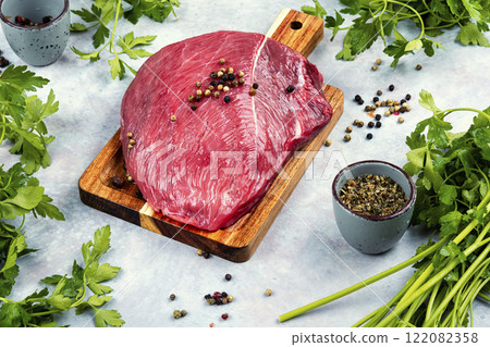 Red veal meat on wooden board. 122082358