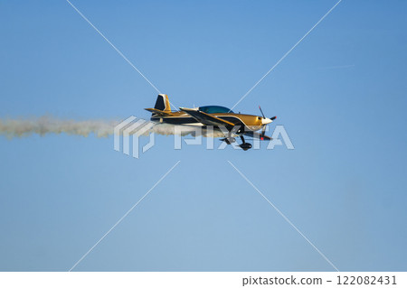 Stunt aerobatic plane performing stunts in air 122082431