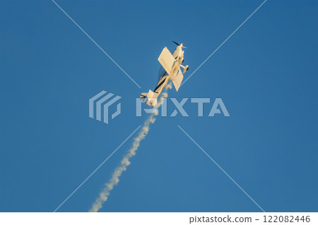 Stunt aerobatic plane performing stunts in air 122082446