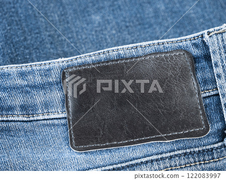 Close-up view of denim fabric highlighting texture and label area for customization 122083997