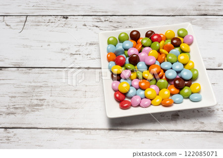Colorful chocolate chunks on a square plate 122085071