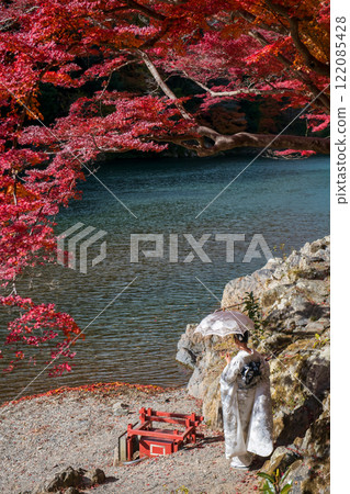 woman in kimonoa and umbrella by red maple leaf in autumn, Arashiyama woman in kimonoa and umbrella by red maple leaf in autumn, Arashiyama 122085428