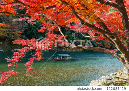 Boatman punt wooden boat along Arashiyama in autumn, Kyoto Boatman punt wooden boat along Arashiyama in autumn, Kyoto 122085429