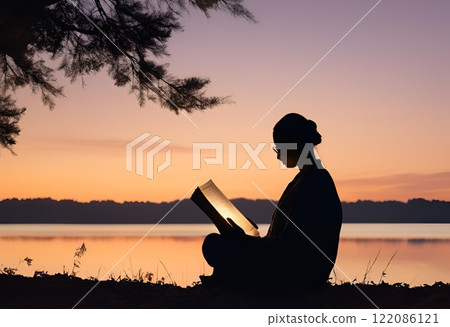 Silhouette of a person reading a book at dusk.AI Generated 122086121