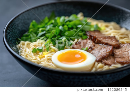 Ramen noodle soup with pork and egg in bowl on black background 122086245
