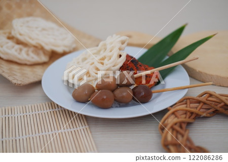 rice with skewered quail eggs and crackers on table 122086286