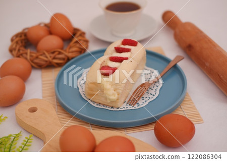Strawberry cheese cake with eggs in basket on a table. 122086304
