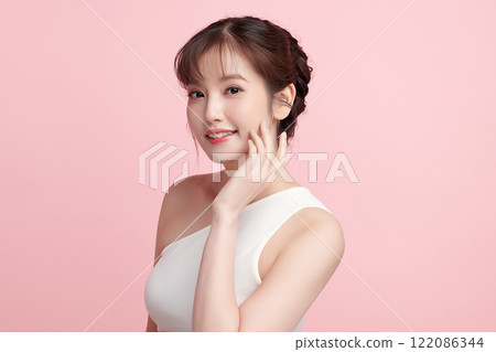 Beautiful young asian woman with clean fresh skin on pink background, Face care, Facial treatment, Cosmetology, beauty and spa, Asian women portrait. Beautiful young asian woman with clean fresh skin on pink background, Face care, Facial treatment, Cosmetology, beauty and spa, Asian women portrait. 122086344