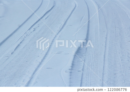 Car tire tracks in fresh snow. traces of wheels on snow from cars 122086776