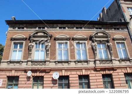 Historic building made of red bricks and big glass windows 122086795