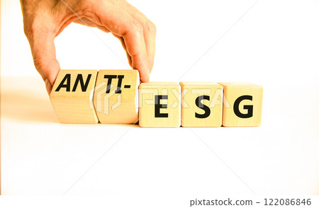 Anti-ESG environment social governance symbol. Concept word Anti-ESG on wooden cubes. Businessman hand. Beautiful white background. Business Anti-ESG environment social governance concept. Copy space Anti-ESG environment social governance symbol. Concept word Anti-ESG on wooden cubes. Businessman hand. Beautiful white background. Business Anti-ESG environment social governance concept. Copy space 122086846