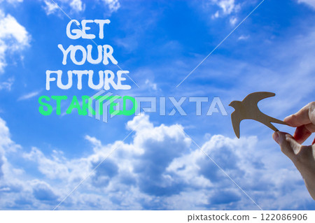 Get your future started symbol. Concept words Get your future started. Beautiful blue sky and clouds background. Businessman hand with wooden bird. Business get your future started concept. Copy space Get your future started symbol. Concept words Get your future started. Beautiful blue sky and clouds background. Businessman hand with wooden bird. Business get your future started concept. Copy space 122086906