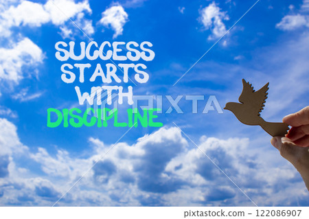Success starts with discipline symbol. Concept words Success starts with discipline. Beautiful blue sky and clouds background. Business success starts with discipline concept. Copy space Success starts with discipline symbol. Concept words Success starts with discipline. Beautiful blue sky and clouds background. Business success starts with discipline concept. Copy space 122086907