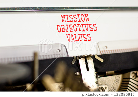 Mission objectives values symbol. Concept words Mission Objectives Values typed on beautiful old retro typewriter. Beautiful white background. Business mission objectives values concept. Copy space. 122086915
