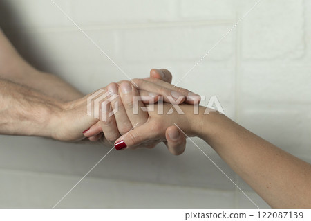 a woman's hand is held by a man's hands, love concept 122087139
