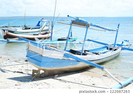 Quiet Beach with Traditional Boat and Clear Blue Waters Quiet Beach with Traditional Boat and Clear Blue Waters 122087263