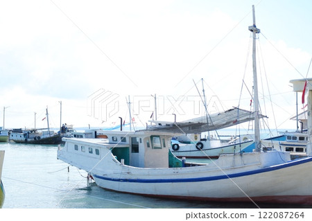 Quiet Beach with Traditional Boat and Clear Blue Waters Quiet Beach with Traditional Boat and Clear Blue Waters 122087264