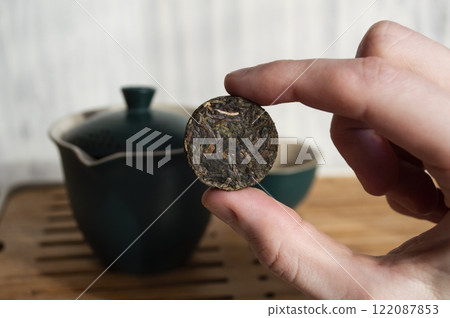 Sheng Puer pressed into a circle in hand Sheng Puer pressed into a circle in hand 122087853