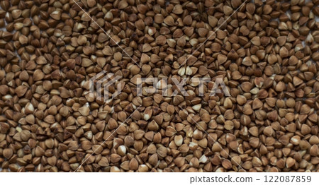 Texture of loose buckwheat on the table 122087859