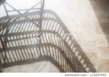 Shadow from a chair on a wooden floor Shadow from a chair on a wooden floor 122087885