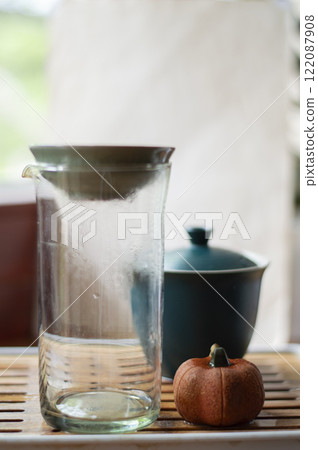 Tea glass and ceramic teapot on the wooden tea table. Tea ceremony Tea glass and ceramic teapot on the wooden tea table. Tea ceremony 122087908