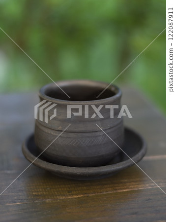 Clay bowl and plate on wooden table Clay bowl and plate on wooden table 122087911