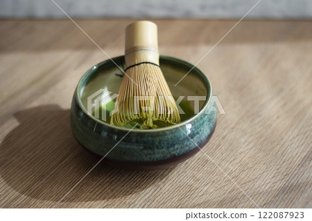 Matcha green tea cup with bamboo whisk on wooden table Matcha green tea cup with bamboo whisk on wooden table 122087923
