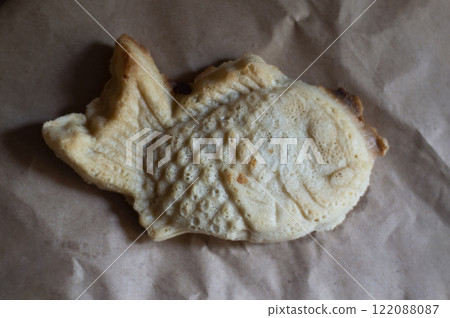 Japanese cookies in the shape of a fish. Taiyaki on paper Japanese cookies in the shape of a fish. Taiyaki on paper 122088087