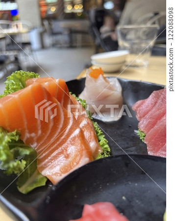Salmon and tuna Sashimi on black plate in restaurant Salmon and tuna Sashimi on black plate in restaurant 122088098