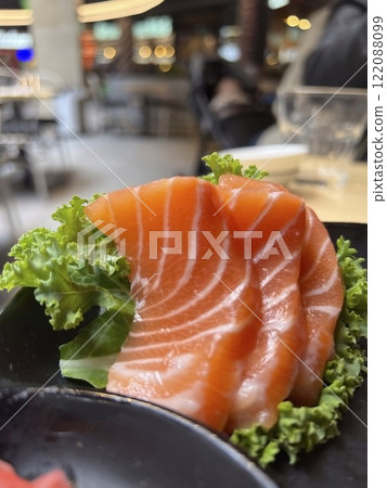 Salmon sashimi on black plate, japanese food in restaurant. Salmon sashimi on black plate, japanese food in restaurant. 122088099