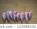 Shrimps on wooden cutting board 122088102
