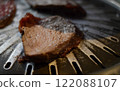 Beef steak on a barbecue grill, close up 122088107