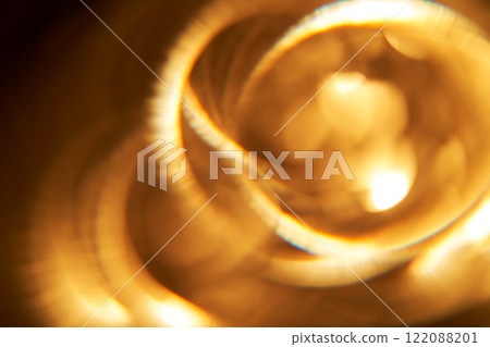 Abstract festive golden background with bright lines of light. 122088201