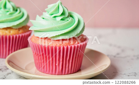 Colorful cupcakes with green frosting create a delightful dessert display in a pastel setting 122088266