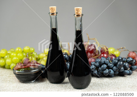 Balsamic vinegar in bottles among grapes Balsamic vinegar in bottles among grapes 122088500