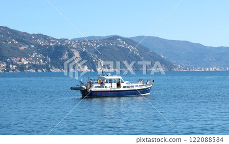 Santa Margherita, Italy - November 13, 2024. Motorboat Cavatina in marina on sunny summer day. School for learning to sail. Mountains and sea, way of life.  122088584