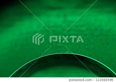 Green liquid surface, fantastic bubbles in the darkness, dark fantastic background, transparent forms, empty space, dark background 122088596
