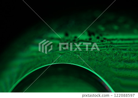 Green liquid surface, fantastic bubbles in the darkness, dark fantastic background, transparent forms, empty space, dark background 122088597