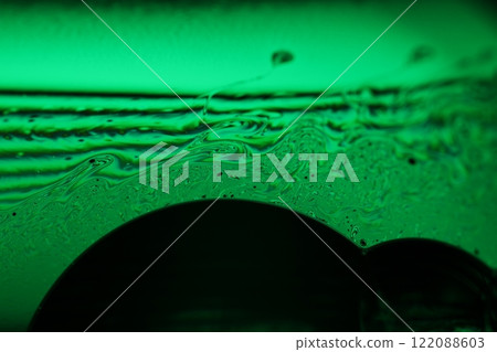 Green liquid surface, fantastic bubbles in the darkness, dark fantastic background, transparent forms, empty space, dark background 122088603