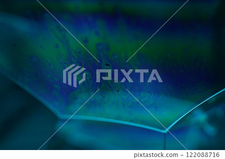 Bright blue surface on black background, oil stains movement, bright chemistry, surreal background, rainbow colours Bright blue surface on black background, oil stains movement, bright chemistry, surreal background, rainbow colours 122088716